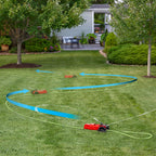 An oscillating sprinkler is watering a well-manicured lawn in a residential garden. Blue arrows illustrate the sprinkler's coverage path between trees and shrubs.
