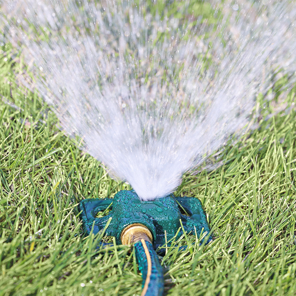 Melnor Square Spot Sprinkler spraying stream of water over green lawn