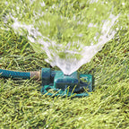 Melnor Square Spot Sprinkler spraying stream of water over green lawn