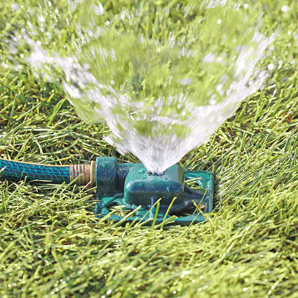 Melnor Square Spot Sprinkler spraying stream of water over green lawn