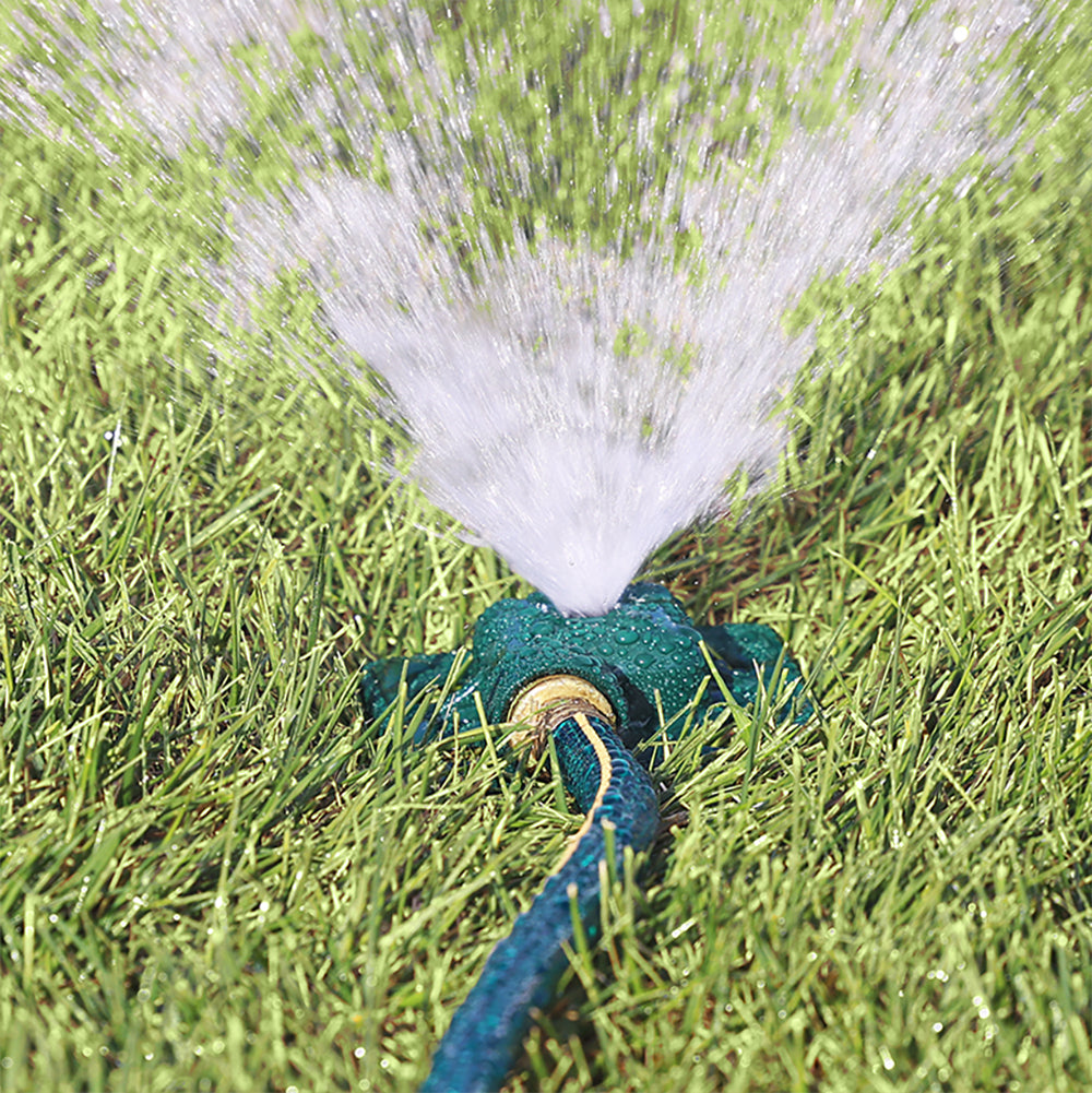 Melnor Square Spot Sprinkler spraying stream of water over green lawn