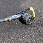 Melnor Torrent Hose Nozzle laying on asphalt driveway