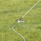Melnor Metal Pulsating Sprinkler with Wheeled Base watering a green grass