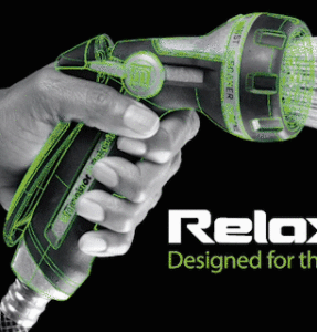 A person's hand gripping a stylized green and black cordless drill with white outlines. Text reads "Relax - Designed for the creative", suggesting brand marketing.