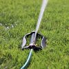 Side view of the Melnor XT 4,000 Sq. Ft. Oscillating Sprinkler gently spraying water