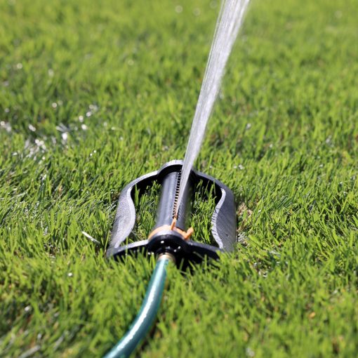Side view of the Melnor XT 4,000 Sq. Ft. Oscillating Sprinkler gently spraying water